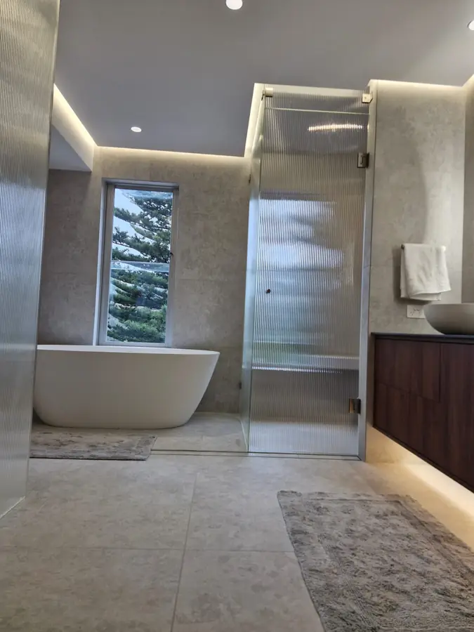 Marble floor tiling beneath a dark timber vanity