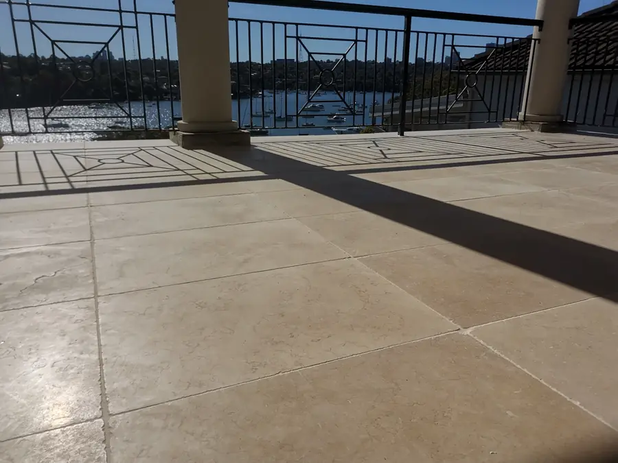 Detail of large-format terrace tiling with ironwork shadow lines