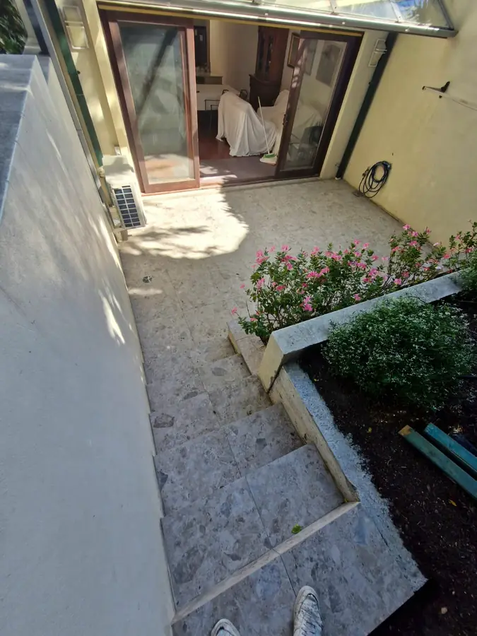 Travertine tiled outdoor steps and garden path